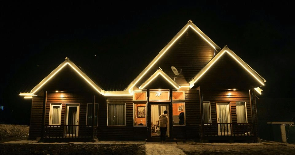 A confident man walking safely through a smart city at night 
with glowing blue digital shield icons representing the power 
of Hi Thealite personal safety and cybersecurity protection